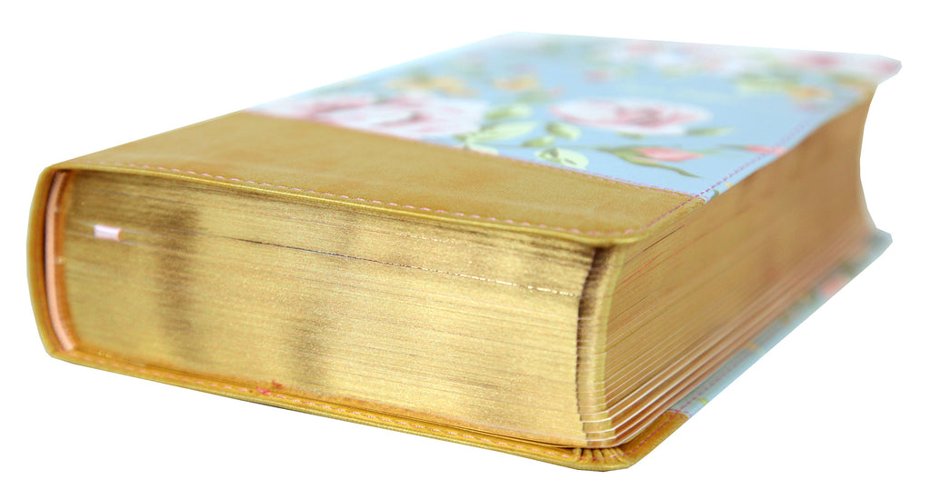 Teen girl holding and reading NIV True Images Bible in Blue and Gold, Black Letter Edition