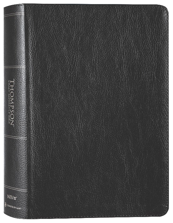 NIV Thompson Chain-Reference Bible, black leather cover with red letter edition, on a wooden desk