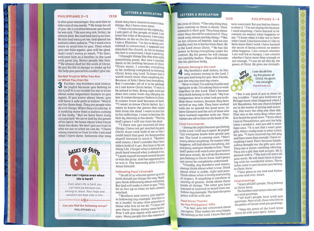 NIRV Tiny Theologians Bible, Blue, a compact Bible featuring the New International Reader's Version, open on a desk