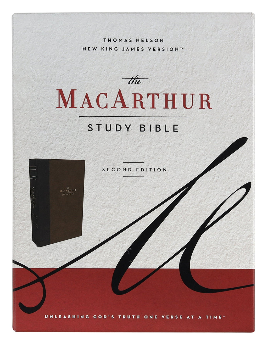 NKJV MacArthur Study Bible in Brown leather (2nd Edition) open on a desk with a pen.