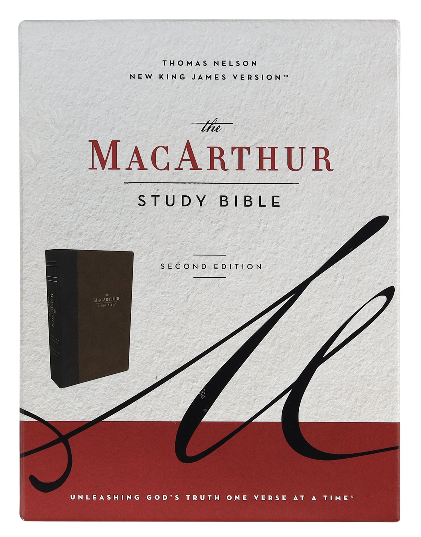 NKJV MacArthur Study Bible in Brown leather (2nd Edition) open on a desk with a pen.