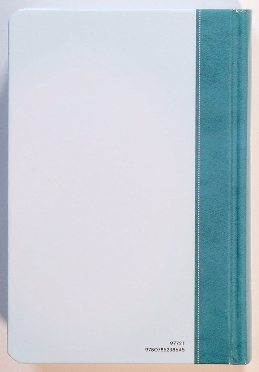 NKJV Precious Moments Small Hands Bible Teal on a table with other kids' books