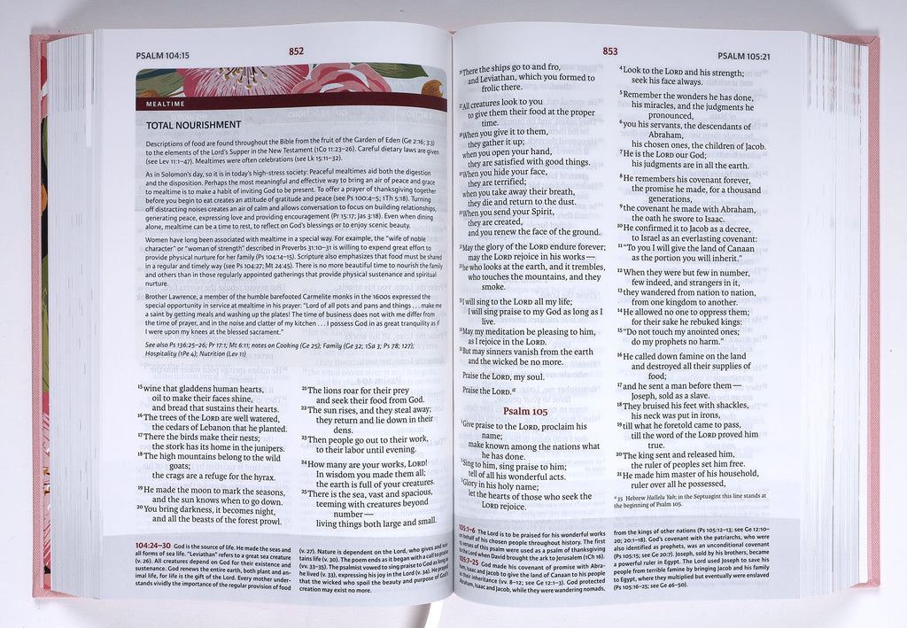 A woman holding the NIV Woman's Study Bible Pink Edition, reading and taking notes on its pages.
