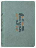 Sage green NLT One Year Chronological Study Bible open on a desk.