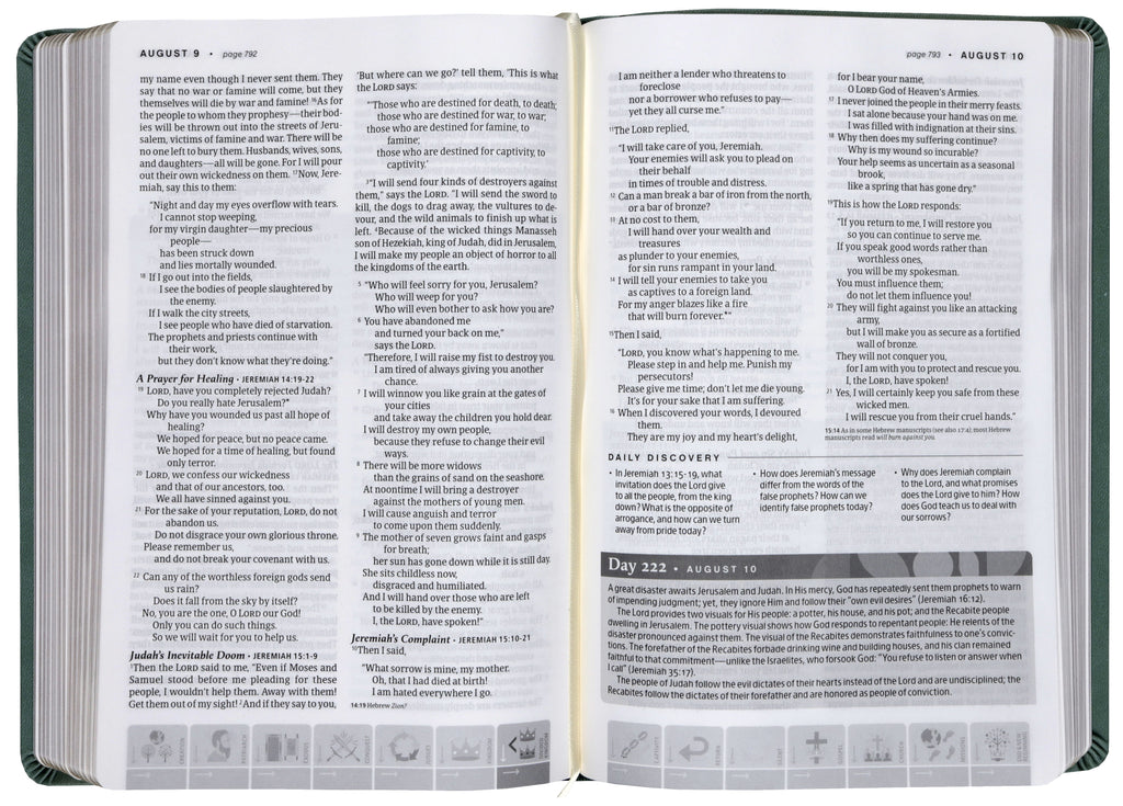 Sage green NLT One Year Chronological Study Bible lying open on a reading table.