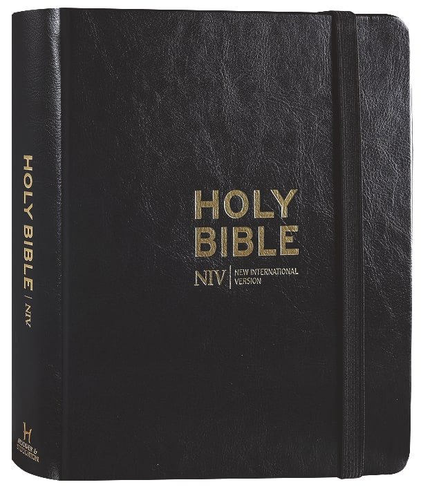 Lifestyle photo of the NIV Anglicised Text Journaling Bible with Black Elastic Strap in a daily setting.