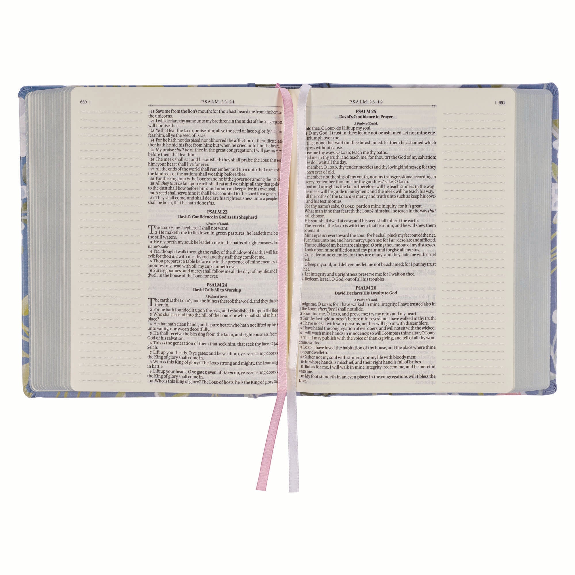 KJV journaling Bible with blue floral cover and black letter text open on a desk.